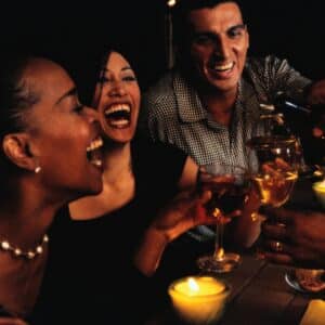 Friends laughing and drinking wine