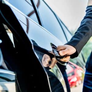 A chauffeur opening a car door
