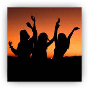 Silhouette of three women at a sunset