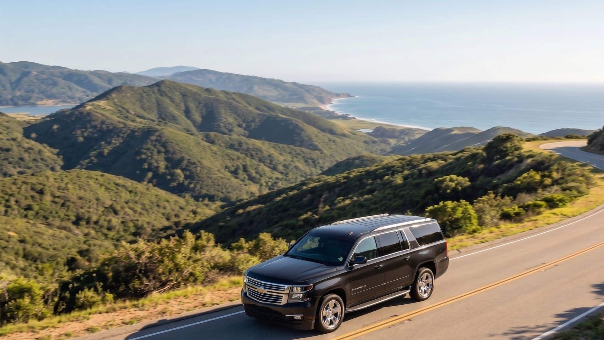 black car driving near the coast